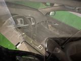 a view of a car through the windshield of a car