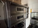 two ovens that are in a kitchen next to each other