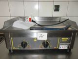 une photo d'un plan de travail en acier inoxydable sur lequel est posée une plaque de cuisson
