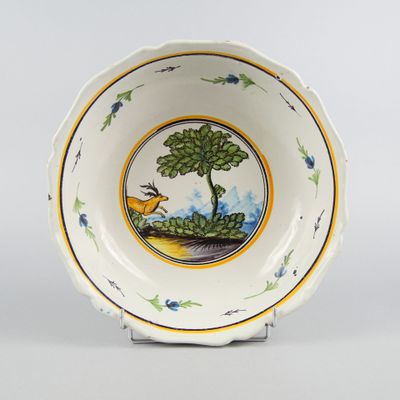 an image of a bowl with a deer and tree on it