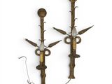 pair of antique wall sconces in the form of swords