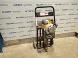 a machine that is sitting on the ground in front of a wall