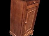 a wooden cabinet with a marble top on a black background
