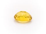 a yellow sapphire stone on a white background