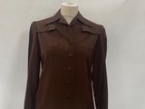 a woman ' s brown jacket on a mannequin dummy