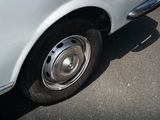 a white car that is parked on the side of the road