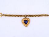 a close up of a bracelet with a heart on it
