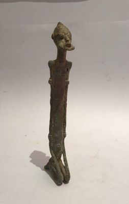 a small statue of a man with a hat on his head