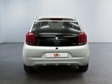 a small white car that is parked in a room