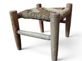 an image of a wooden stool with a rope seat on it