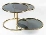 two tiered glass and brass side tables with mirrors on them
