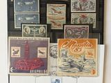 many different stamps displayed on the wall of this room