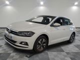 the white volkswagen polo is parked in a room with a checkered floor