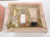 a bottle of perfume and a bottle of lotion in a box