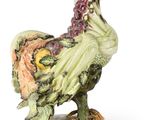 a figurine of a rooster on a plate
