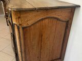 a wooden cabinet in the corner of a room