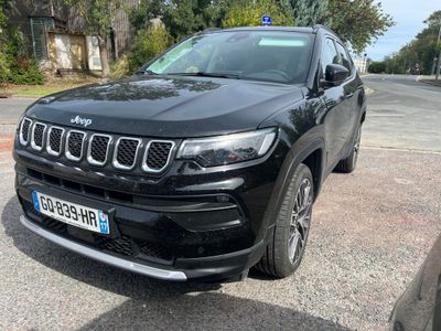 the jeep compass is parked on the side of the road