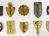 a lot of different types of badges on a white surface