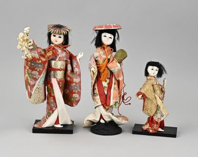 three asian dolls of women in kimono and geisha outfits