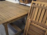 many wooden chairs and a table in a room
