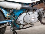 a close up of a blue motorcycle parked on the side of the road