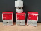 three boxes of water dispensers sitting on a wooden table
