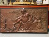 a large bronze plaque of a woman and two children