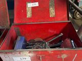 a red box with tools in it sitting on the floor