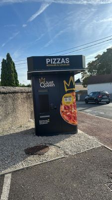 a pizza vending machine on the side of the road