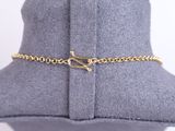 a close up of a mannequin with a gold chain on it
