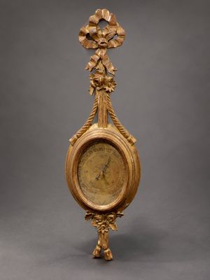 an antique gold clock with ornate decoration on a gray background