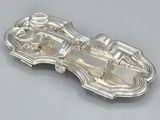 an antique silver plate with a horse and carriage design on it