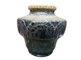 a vase that is sitting on a white surface