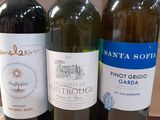 three bottles of wine are lined up on a table