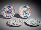 trois assiettes ornées de motifs floraux et d'oiseaux, posées sur une table