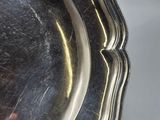 a close up of a silver plate on a table