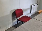 tables and chairs in a room with a radiator and a heater