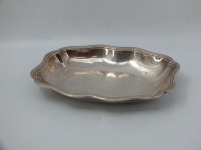 a silver plate with a wavy edge on a white surface