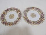 deux assiettes à motifs floraux posées sur une surface blanche