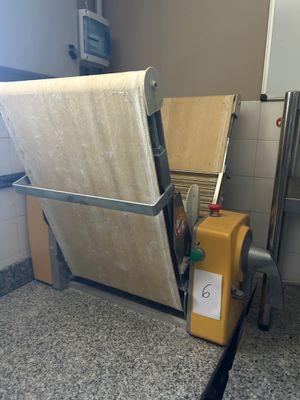 a mattress on a cart in a kitchen next to a stove