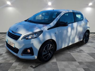 the white car is parked in a large room with a checkered floor