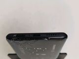 the back of a cell phone with a broken screen sitting on top of a stand