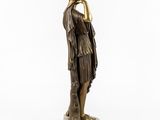 a bronze statue of a woman holding her head in her hands