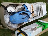 a blue bag sitting on top of a cardboard box on the grass