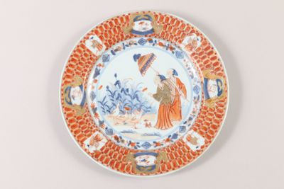 a plate with a picture of a woman and a bird on it