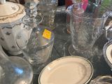 a glass table with a lot of glass items on it