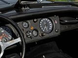 a steering wheel and dashboard of a car with a clock on it