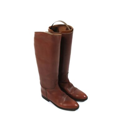 a pair of brown leather boots on a white background