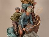 figurine représentant un groupe d'hommes dans une barque sur un plan d'eau