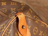a close up of a louis vuitton bag on a table
